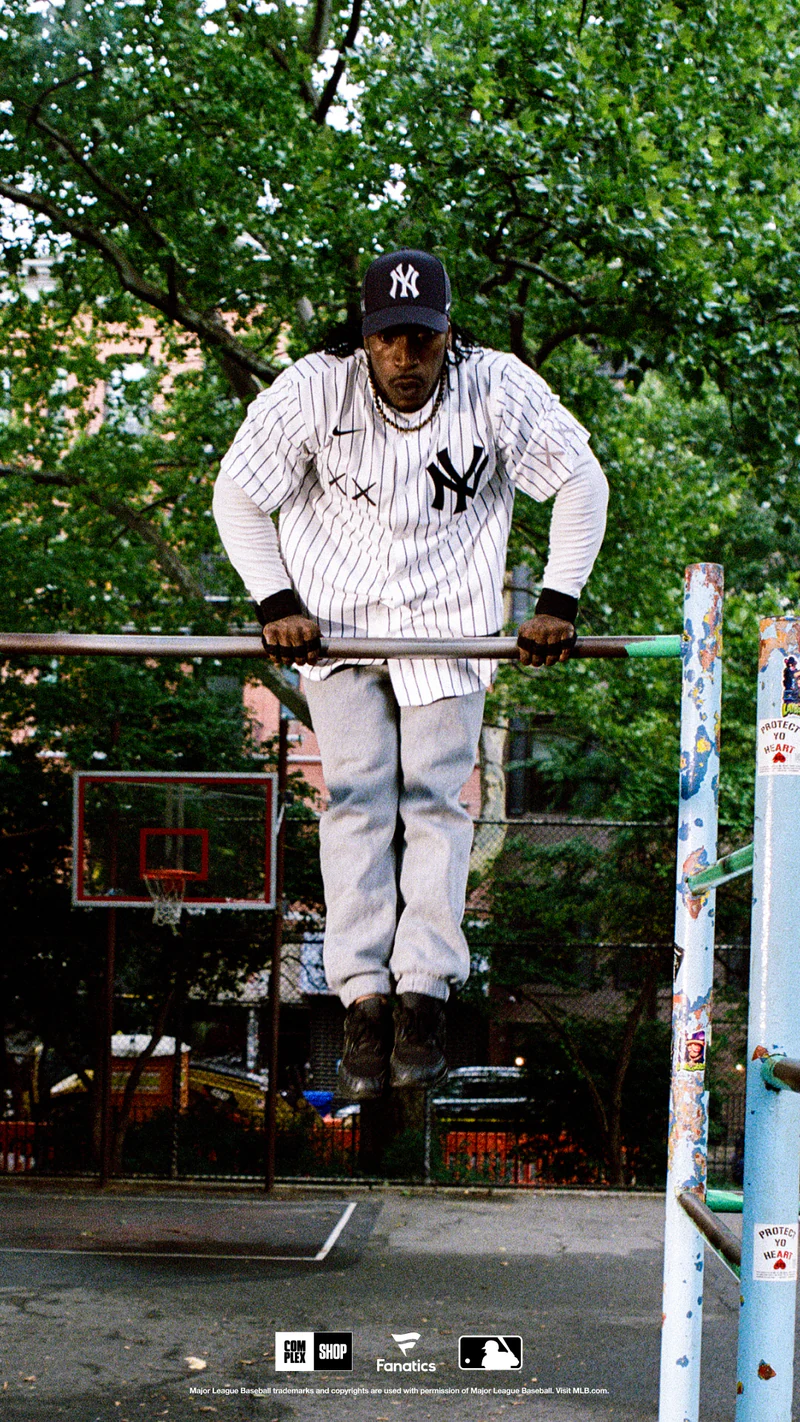 A man wearing the Yankees pieces on an outdoor bar in New York.
