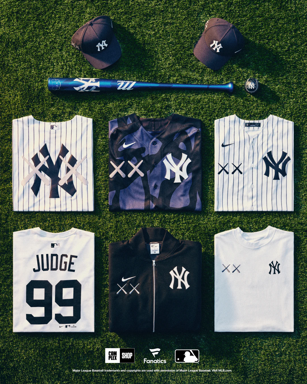 Yankees pieces from the KAWS × MLB collection laid out on grass.